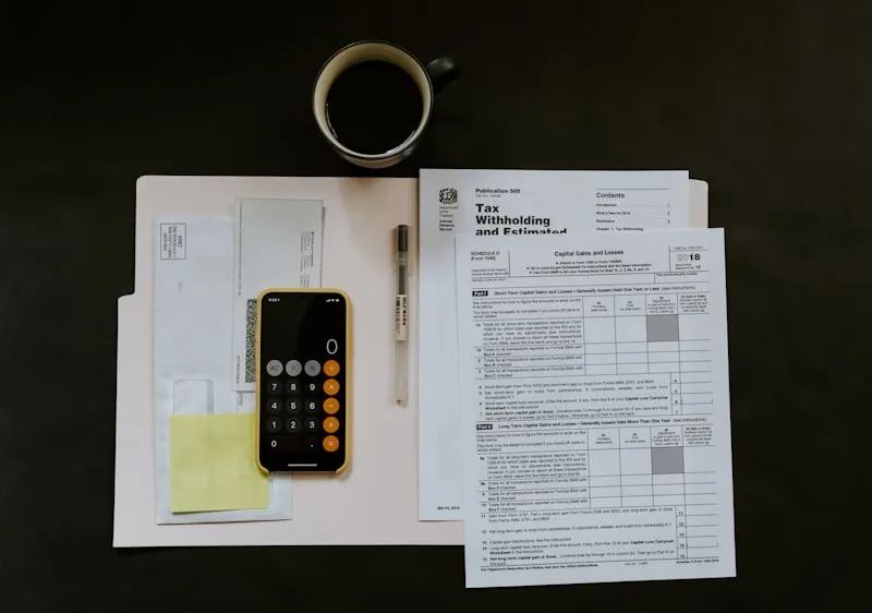 Calculator and financial documents on a business desk