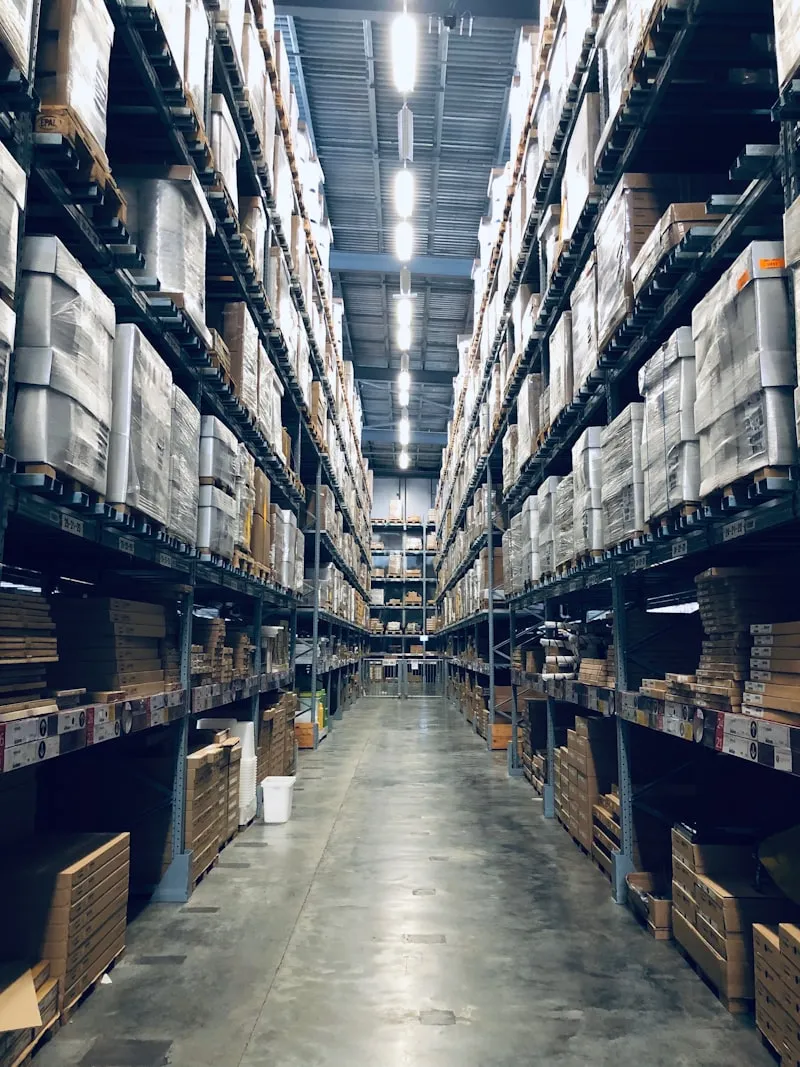 Organized warehouse shelving with inventory boxes representing cost of goods